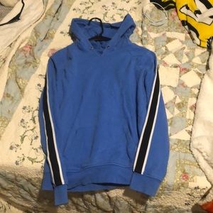light blue hoodie; black strips down the sleeves